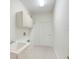Bright laundry room featuring a sink, cabinets, and a door at 1125 English Garden Ln, Winter Garden, FL 34787