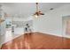 Bright living space adjacent to the kitchen, offering hardwood floors and a ceiling fan at 1125 English Garden Ln, Winter Garden, FL 34787