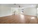 Bright and spacious living room features wood floors, a ceiling fan, and staircase access to another level at 1125 English Garden Ln, Winter Garden, FL 34787