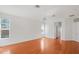 Bright living room with hardwood floors, a ceiling fan, and two windows providing natural light at 1125 English Garden Ln, Winter Garden, FL 34787