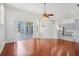 Open-concept living area connects to a modern kitchen, featuring hardwood floors and ample natural light at 1125 English Garden Ln, Winter Garden, FL 34787
