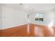 Spacious living room featuring hardwood floors, a ceiling fan, and sliding glass doors providing outdoor access at 1125 English Garden Ln, Winter Garden, FL 34787