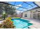Sparkling pool with a screened enclosure, complemented by lush landscaping and a relaxing spa at 1125 English Garden Ln, Winter Garden, FL 34787