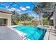 Backyard features a sparkling pool with spa, screened enclosure, and a spacious patio area at 1125 English Garden Ln, Winter Garden, FL 34787