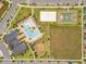 Aerial view displays a community pool, basketball and volleyball courts, playground, and other amenities at 11865 Ginsberg Pl, Orlando, FL 32832
