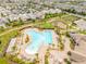 Aerial view features a community pool, clubhouse, and playground near a residential area at 11865 Ginsberg Pl, Orlando, FL 32832