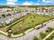Aerial view of a community park with a playground and a large field surrounded by residential homes at 11865 Ginsberg Pl, Orlando, FL 32832