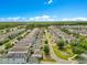 Aerial view showing the layout of a housing community with modern homes and green spaces at 11865 Ginsberg Pl, Orlando, FL 32832