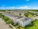 An aerial view of a residential neighborhood with well-maintained homes and lush green landscaping, featuring houses with solar panels at 11865 Ginsberg Pl, Orlando, FL 32832