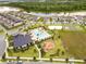 Aerial view displays a community pool, playground, and lake near residential homes at 11865 Ginsberg Pl, Orlando, FL 32832