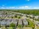 Overview of residential neighborhood showcasing houses with solar panels and manicured lawns at 11865 Ginsberg Pl, Orlando, FL 32832