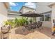 Inviting patio area with outdoor seating, lush landscaping, and ambient string lighting at 11865 Ginsberg Pl, Orlando, FL 32832