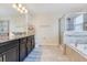 Modern bathroom featuring granite countertops, a soaking tub, and a glass-enclosed shower at 11865 Ginsberg Pl, Orlando, FL 32832