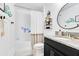 Bright bathroom with a modern vanity, granite counters and a shower-tub combination at 11865 Ginsberg Pl, Orlando, FL 32832
