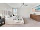 Elegant bedroom with a plush bed, stylish dresser, and a ceiling fan at 11865 Ginsberg Pl, Orlando, FL 32832