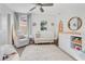 Bright Bedroom with a white crib, decorated with a surfboard and other decorations, and lots of natural light at 11865 Ginsberg Pl, Orlando, FL 32832