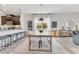 A view of the open dining area with pendant lighting, seating for six, and a view into the kitchen at 11865 Ginsberg Pl, Orlando, FL 32832