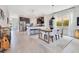 Bright dining room with a modern table, chairs, and open view of the kitchen, great for entertaining guests at 11865 Ginsberg Pl, Orlando, FL 32832
