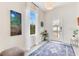 Bright foyer with a stylish rug, decorative artwork, and ample natural light at 11865 Ginsberg Pl, Orlando, FL 32832