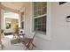 Inviting front porch with chairs, perfect for relaxing and enjoying the neighborhood at 11865 Ginsberg Pl, Orlando, FL 32832
