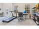 Modern home gym featuring a treadmill, desk setup, and plenty of natural light at 11865 Ginsberg Pl, Orlando, FL 32832