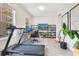 Bright, spacious home office featuring sleek shelves and a state-of-the-art treadmill at 11865 Ginsberg Pl, Orlando, FL 32832