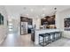 Modern kitchen with stainless steel appliances, dark cabinetry, granite countertops, and an eat-in island at 11865 Ginsberg Pl, Orlando, FL 32832