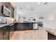 Modern kitchen with a large island, barstool seating, and views to the open floorplan and dining area at 11865 Ginsberg Pl, Orlando, FL 32832