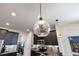 Modern kitchen with stainless steel appliances, dark cabinetry, and stylish pendant lighting at 11865 Ginsberg Pl, Orlando, FL 32832