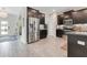 Spacious kitchen with stainless steel appliances, dark cabinetry, and modern countertops at 11865 Ginsberg Pl, Orlando, FL 32832