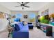 Spacious living room with carpet flooring, large windows, and a comfortable blue sofa at 11865 Ginsberg Pl, Orlando, FL 32832