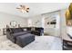 Comfortable living room with a large sectional sofa, stylish decor, and a modern TV at 11865 Ginsberg Pl, Orlando, FL 32832