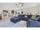 Open-concept living room with a large sectional couch, stylish rug, and plenty of natural light at 11865 Ginsberg Pl, Orlando, FL 32832