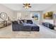 Comfortable living room with a large sectional sofa, stylish decor, and a modern TV at 11865 Ginsberg Pl, Orlando, FL 32832