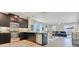 Modern kitchen with stainless steel appliances, dark cabinets, and a view into the dining and living areas at 11865 Ginsberg Pl, Orlando, FL 32832