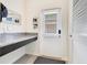 Neat mudroom with counter space, storage, and a door leading to the outside at 11865 Ginsberg Pl, Orlando, FL 32832