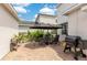 Cozy outdoor patio featuring a dining set, lush greenery, and a barbecue grill, perfect for entertaining at 11865 Ginsberg Pl, Orlando, FL 32832
