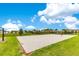 Well-maintained community sand volleyball court with green grass at 11865 Ginsberg Pl, Orlando, FL 32832