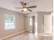 Bedroom featuring a ceiling fan, wood floors, and mirrored closet doors at 3955 Sw 139Th Street Rd, Ocala, FL 34473