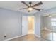 Bedroom featuring a ceiling fan, wood floors, and mirrored closet doors at 3955 Sw 139Th Street Rd, Ocala, FL 34473