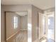 Bedroom featuring wood floors, mirrored closet, and a neutral color palette at 3955 Sw 139Th Street Rd, Ocala, FL 34473