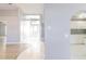 Open entryway that flows into a view of the front door and an open-concept kitchen at 3955 Sw 139Th Street Rd, Ocala, FL 34473