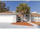 Charming single-story home with an arched entry, well-maintained landscaping, and a two-car garage at 3955 Sw 139Th Street Rd, Ocala, FL 34473