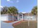 Well-maintained single-story home with mature palm trees, a two-car garage, and an arched front entry at 3955 Sw 139Th Street Rd, Ocala, FL 34473