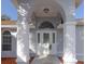Inviting front entrance with arched doorway, decorative glass door, and manicured landscaping at 3955 Sw 139Th Street Rd, Ocala, FL 34473