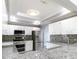 Kitchen features white cabinets, granite countertops, and stainless steel appliances at 3955 Sw 139Th Street Rd, Ocala, FL 34473