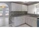 Kitchen features white cabinets and granite countertops at 3955 Sw 139Th Street Rd, Ocala, FL 34473