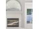 Living room featuring a white fireplace and large window at 3955 Sw 139Th Street Rd, Ocala, FL 34473