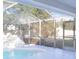 Spacious, screened-in pool lanai showcasing a rock waterfall feature at 3955 Sw 139Th Street Rd, Ocala, FL 34473