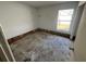Empty bedroom space with a window, a door, and exposed wall studs at 13026 Baltimore Woods Ln, Orlando, FL 32824